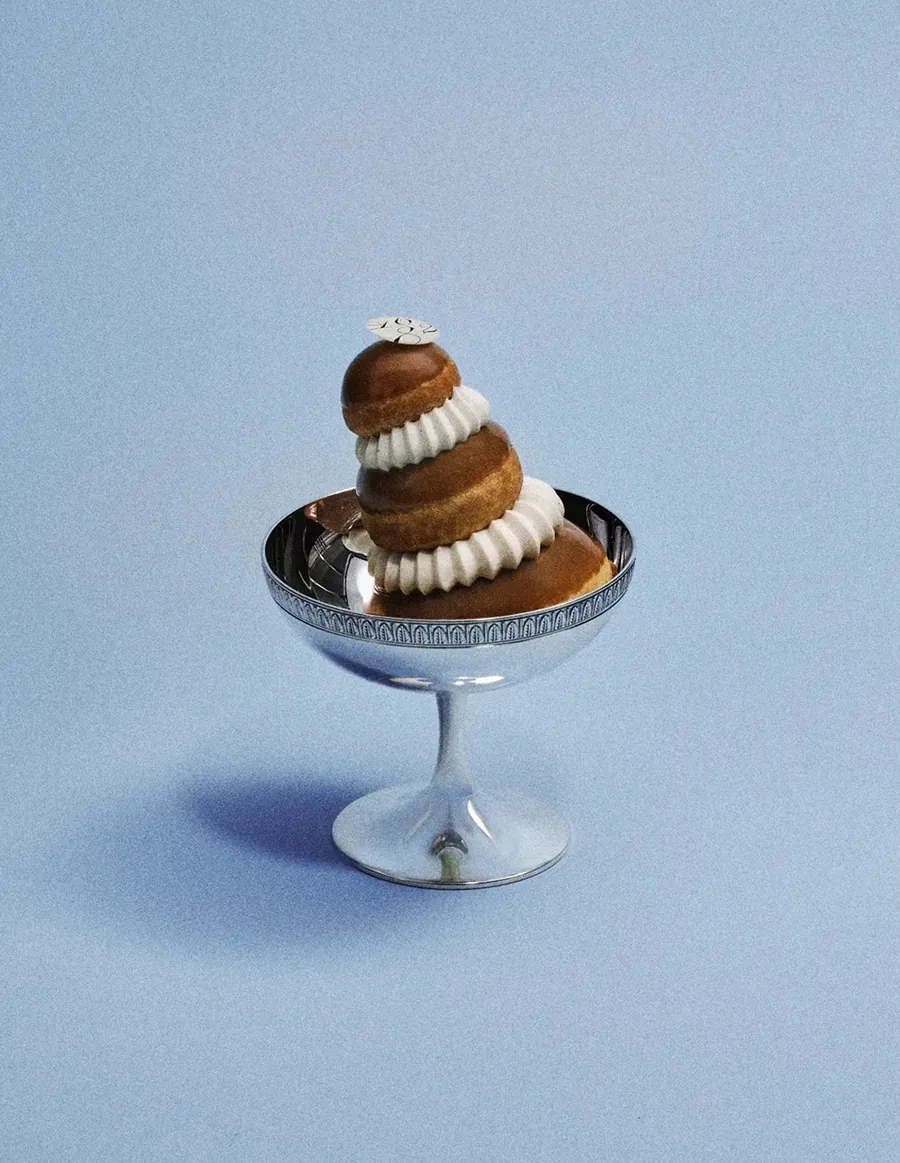 Dalloyau Religieuse in a silver coupe against a pale blue background, photo by Dalloyau