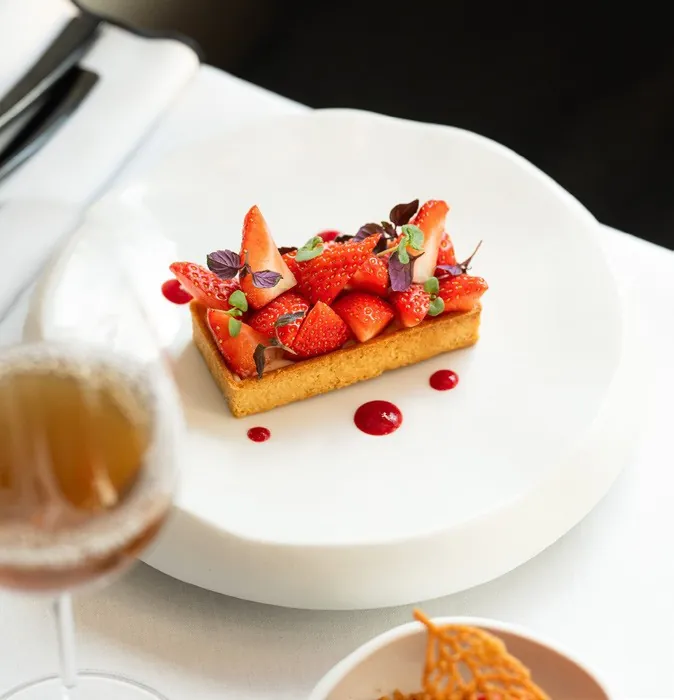 Strawberry tart on a white plate, photo by Fauchon